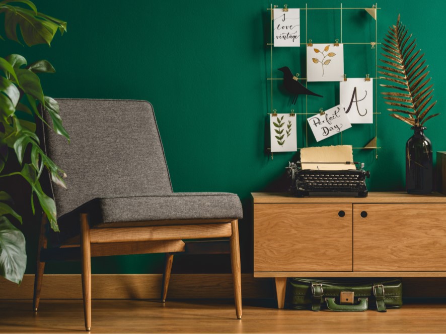 Lush_Green_Hallway_Timber Floor_cabinet_grey_chair_plant_artwork_typewriter_suitcase